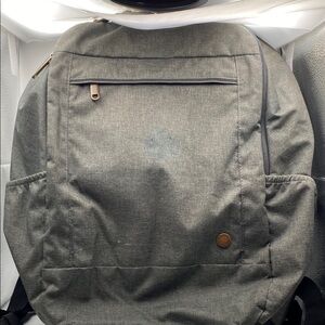 Gray Modern Backpack With Adjustable Straps And Bronze Metal Hardware